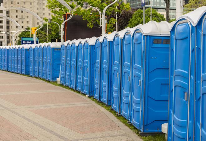 hygienic portable restrooms lined up at a music festival, providing comfort and convenience for attendees in Frisco, TX